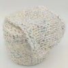 A ball of fluffy white yarn speckled with tiny iridescent sequins, photographed on a clean light gray background.