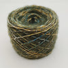 A single ball of variegated yarn with a textured, fuzzy appearance, featuring a blend of olive green, mustard yellow, and dark brown threads, photographed on a clean white background.