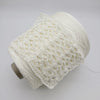 Spools of 100% cotton yarn from Italy, showcasing soft, natural cotton fibers in a variety of neutral shades.