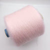 Cream-colored super kid mohair and silk yarn from CRAFT MIND, showcasing soft, luxurious fibers in a close-up view.